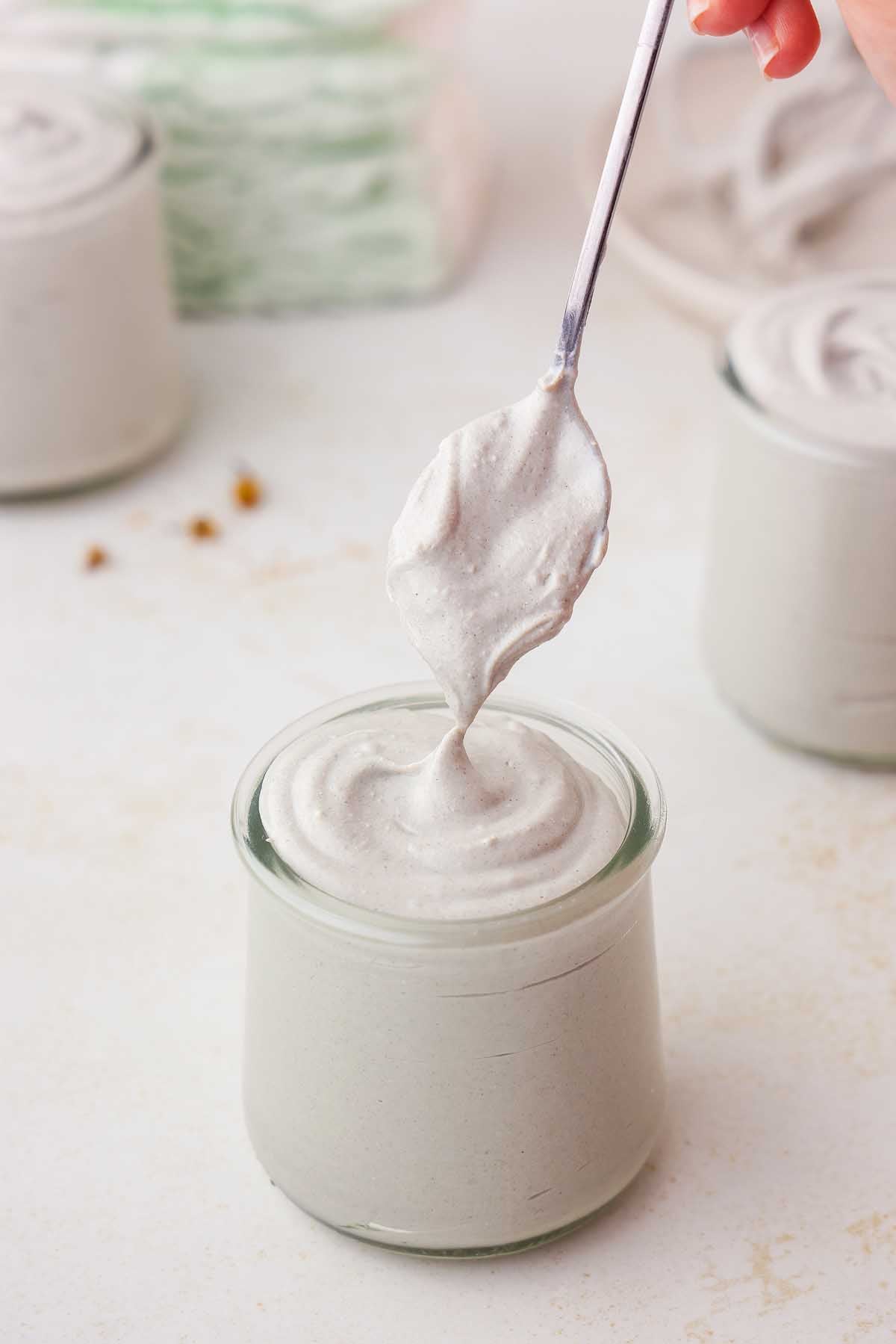 A small jar of homemade diaper rash cream with a scoop being taken.