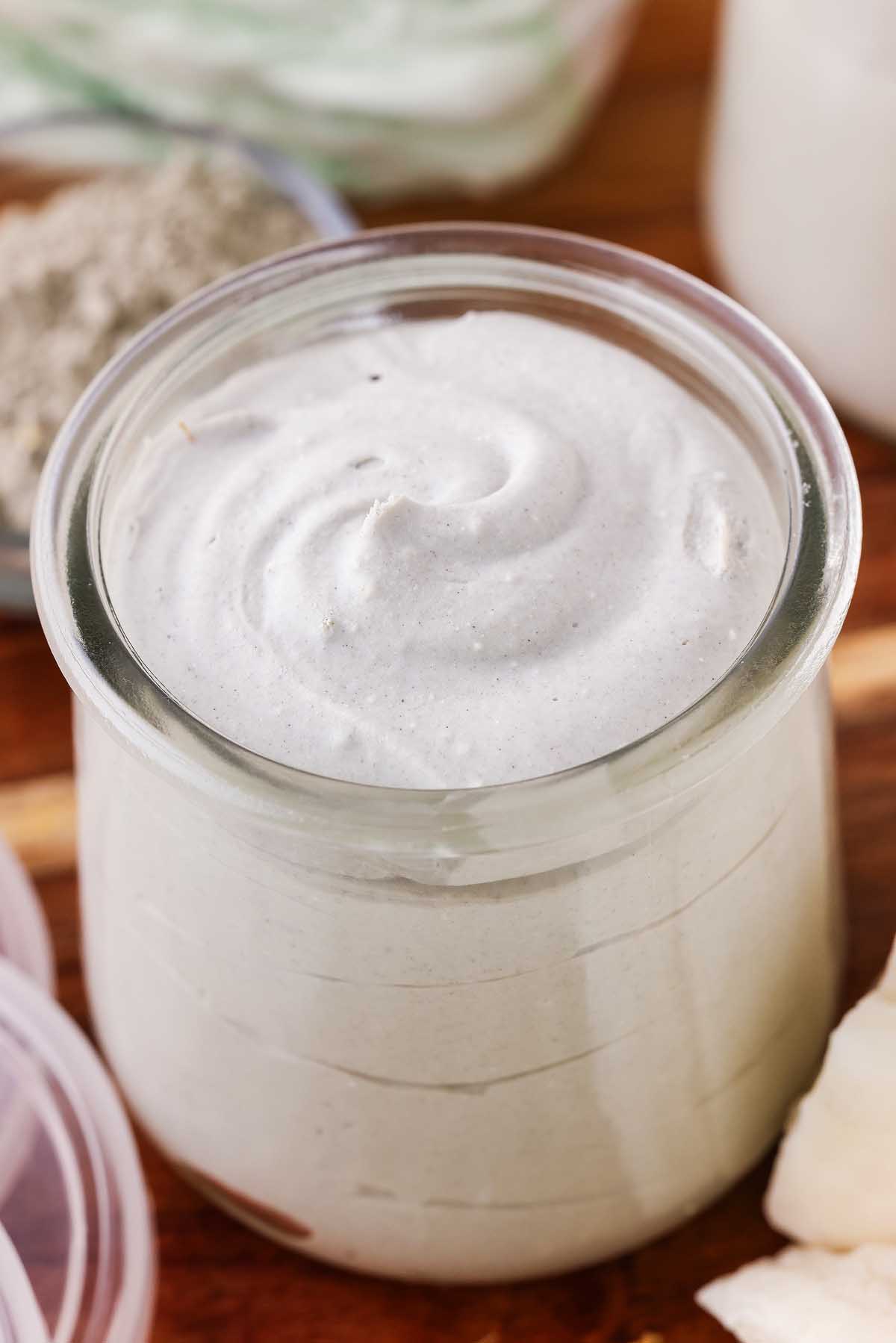 A glass jar of diaper rash cream.