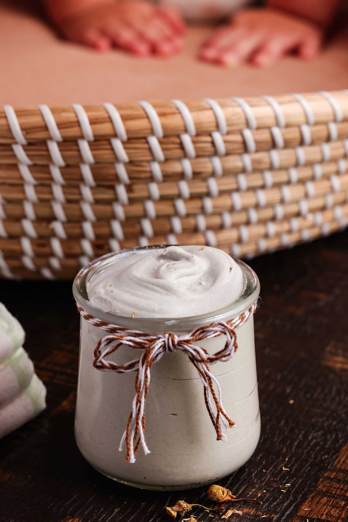 A glass jar with homemade diaper rash cream.