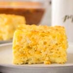 A square slice of Green Chile Egg Casserole sits on a white plate.