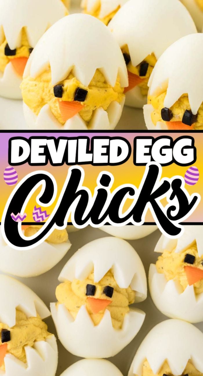 Deviled egg chicks are decorated as cute little chicks, with olives and carrots for eyes and beaks, all arranged on a white surface.