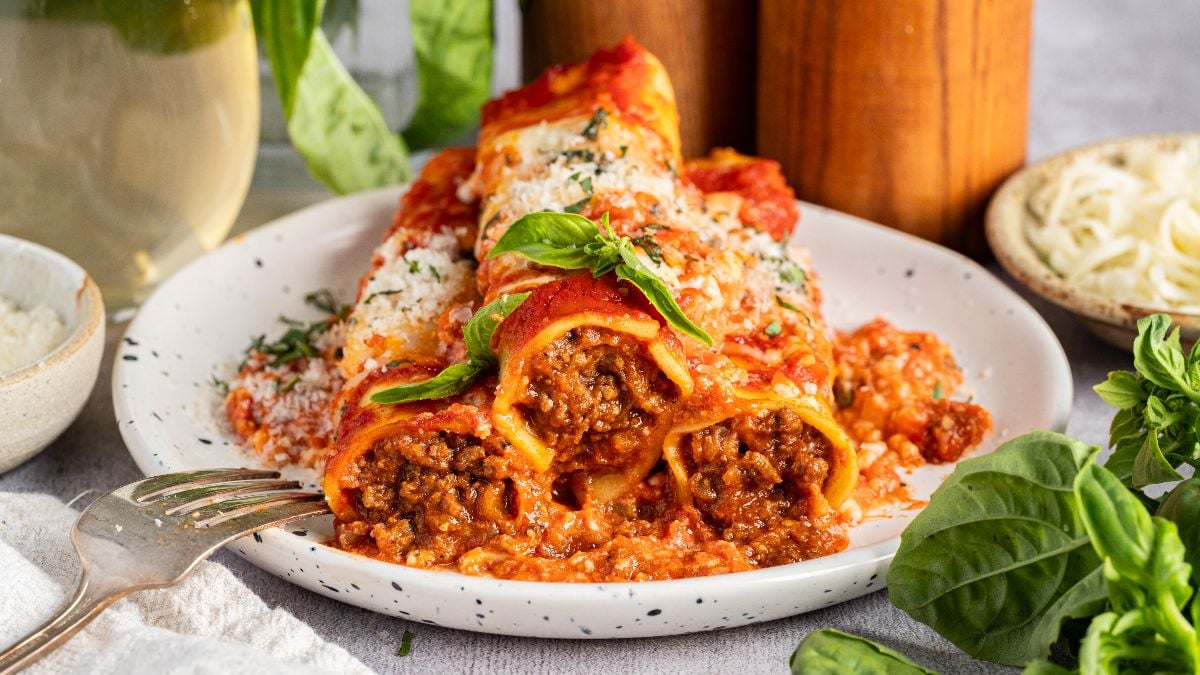 A plate stacked with homemade cannelloni.