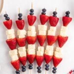 Berry and Pound Cake Skewers featuring strawberries, blueberries, and cake cubes arranged on a white background.