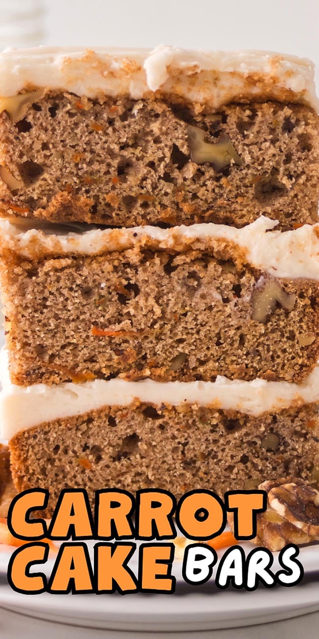 Three frosted carrot cake bars stacked on a plate, with visible nuts and carrot pieces inside, showcase the classic look of homemade carrot cake bars.