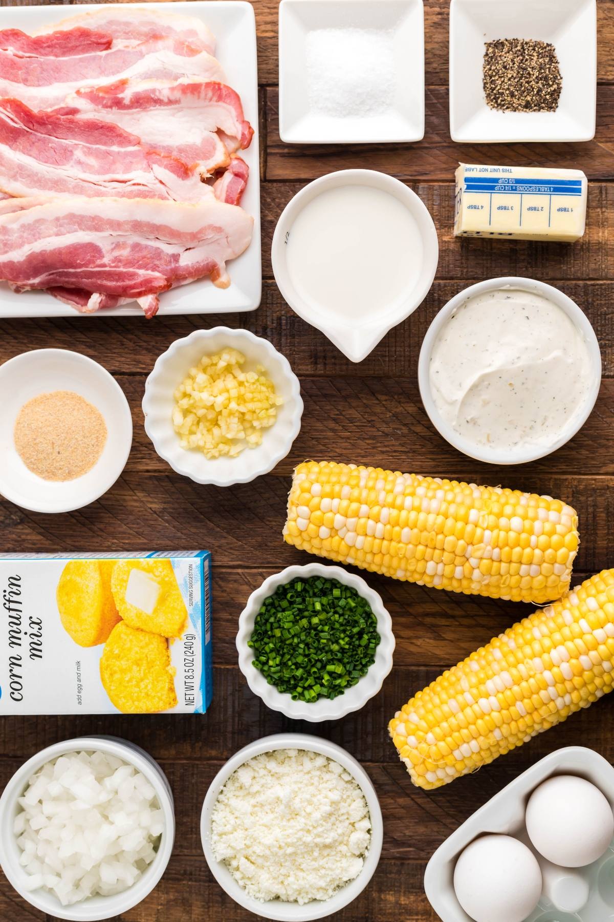 Ingredients for a bacon corn casserole, including corn, eggs, butter, milk, cheese, spices, and Made with Jiffy cornbread mix—perfect for baking or trying as an air fryer cornbread pudding.