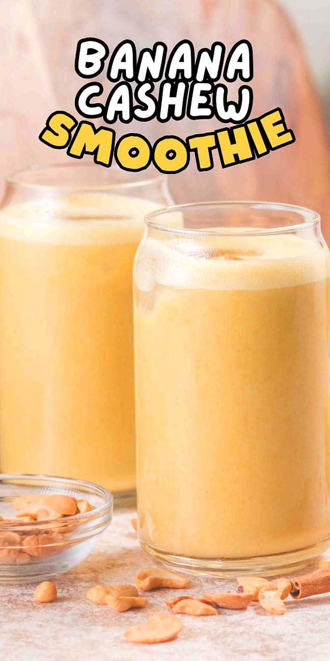 Two glasses of creamy Banana Cashew Smoothie sit beside a small bowl of cashews, ready to enjoy.