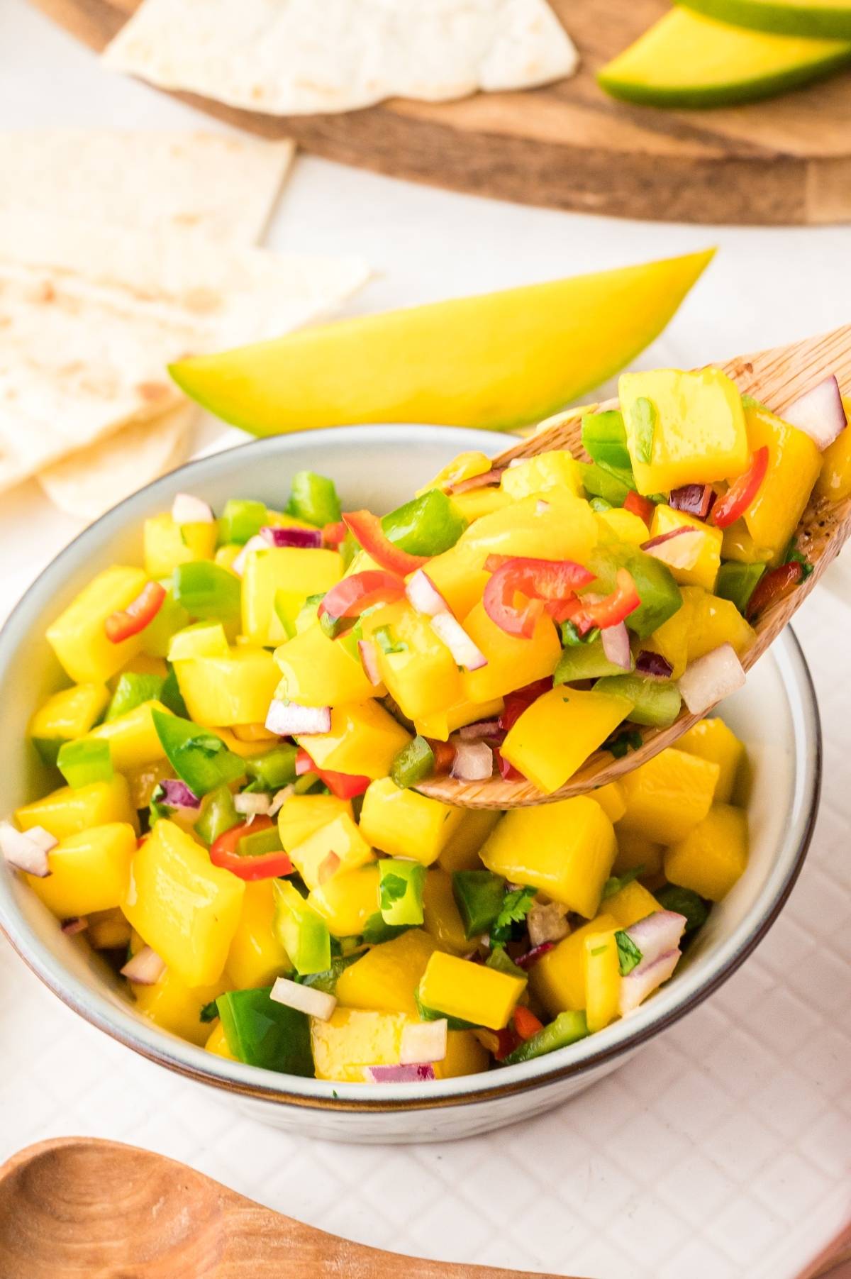 A vibrant Mexican fruit salsa, this summer salsa recipe features diced mango, peppers, onion, and fresh herbs—perfectly served with crunchy tortilla chips.