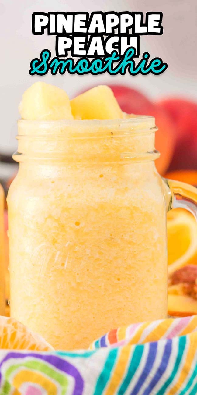 A mason jar filled with a refreshing Pineapple Peach Smoothie, topped with juicy pineapple chunks.