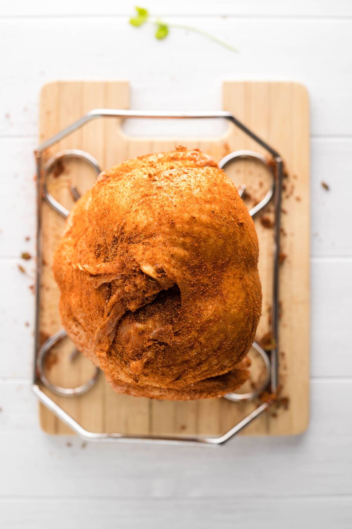 Whole fried chicken on a rack over a wooden cutting board, viewed from above—perfect for those who want to make beer can chicken or serve with zesty Mexican BBQ sauce.