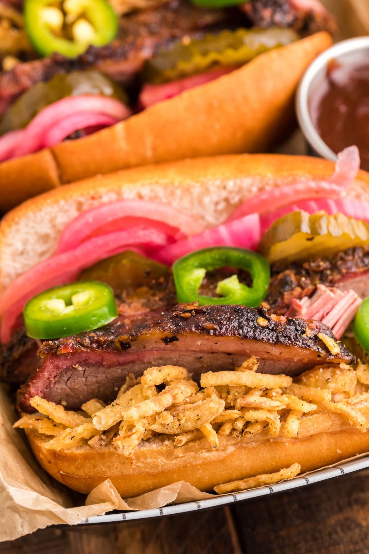 Smoked Brisket Sandwich stacked with pickled onions, jalapeños, and crispy onions in a toasted bun—an irresistible way to enjoy brisket sandwich toppings or use up leftover brisket.