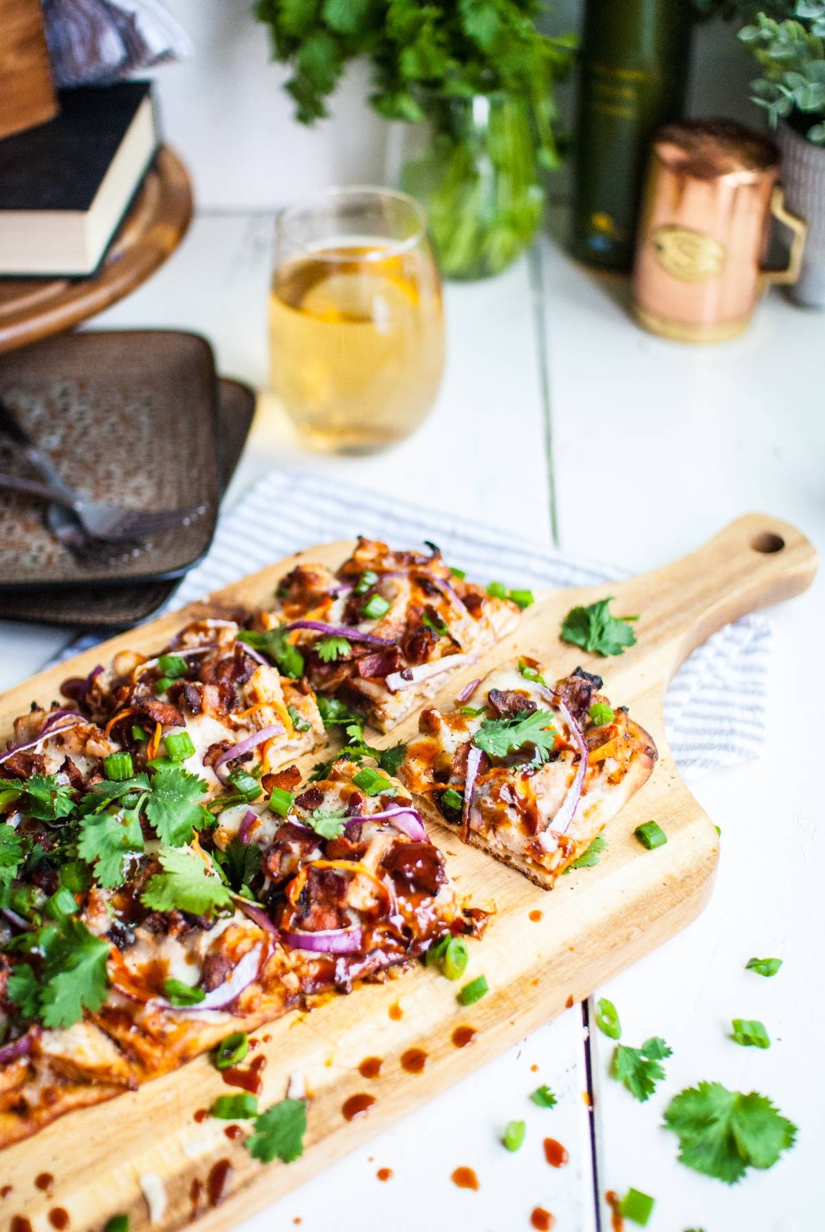 Rectangular BBQ Chicken Flatbread Pizza on a wooden board, topped with cheese, red onions, cilantro, and green onions—just like Panera and made in under 30 minutes.