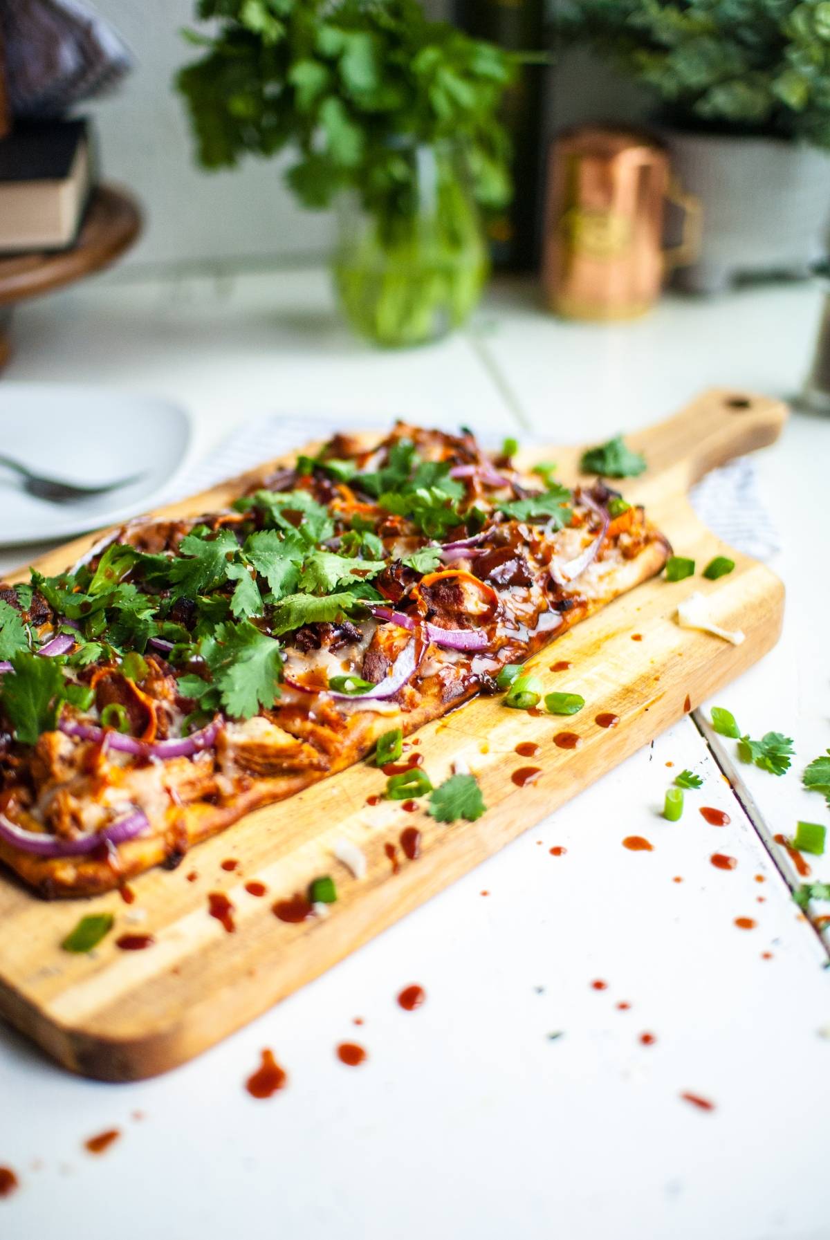 Make flatbread pizza at home with this barbecue chicken flatbread, inspired by Panera. Topped with barbecue sauce, red onions, chicken, and fresh cilantro on a wooden board—made in under 30 minutes.