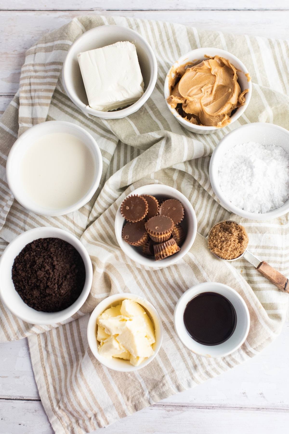 Indulge in bowls filled with cream cheese, peanut butter, milk, powdered sugar, cookies, mini peanut butter cups, butter, vanilla, and sugar—a delicious recipe with peanut butter cups inspired by chocolate peanut butter pie.