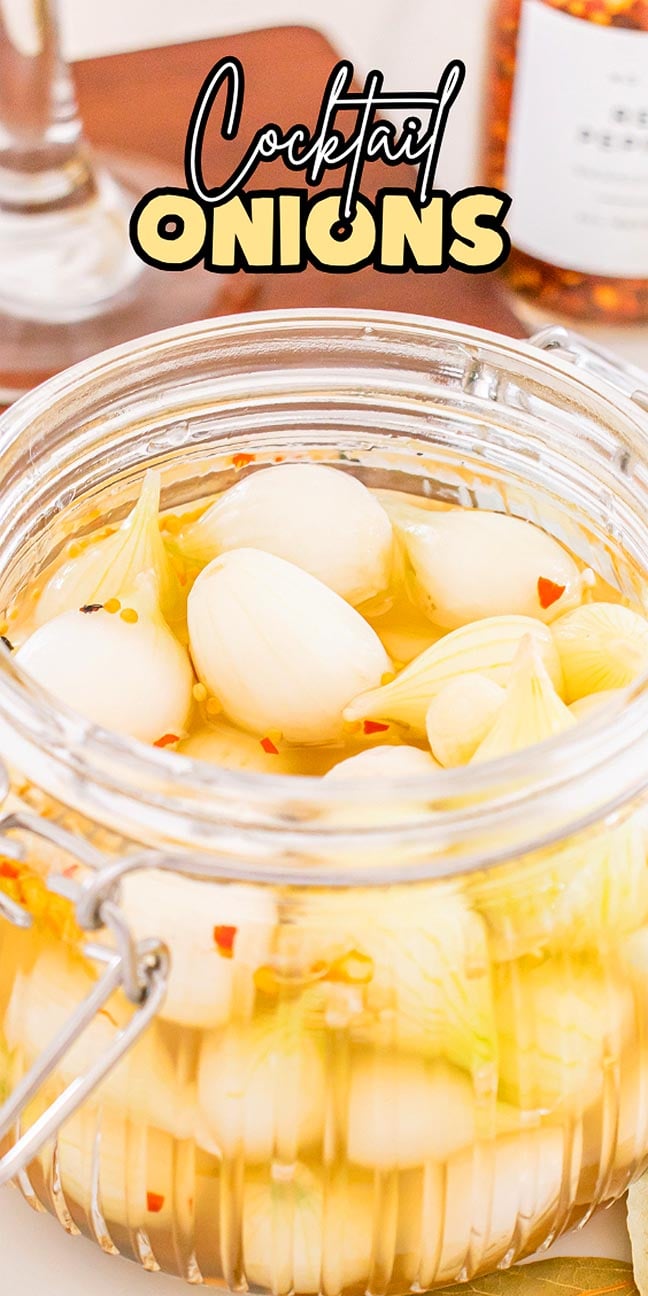 A glass jar filled with cocktail onions in brine, labeled with the text "Cocktail Onions" above it.