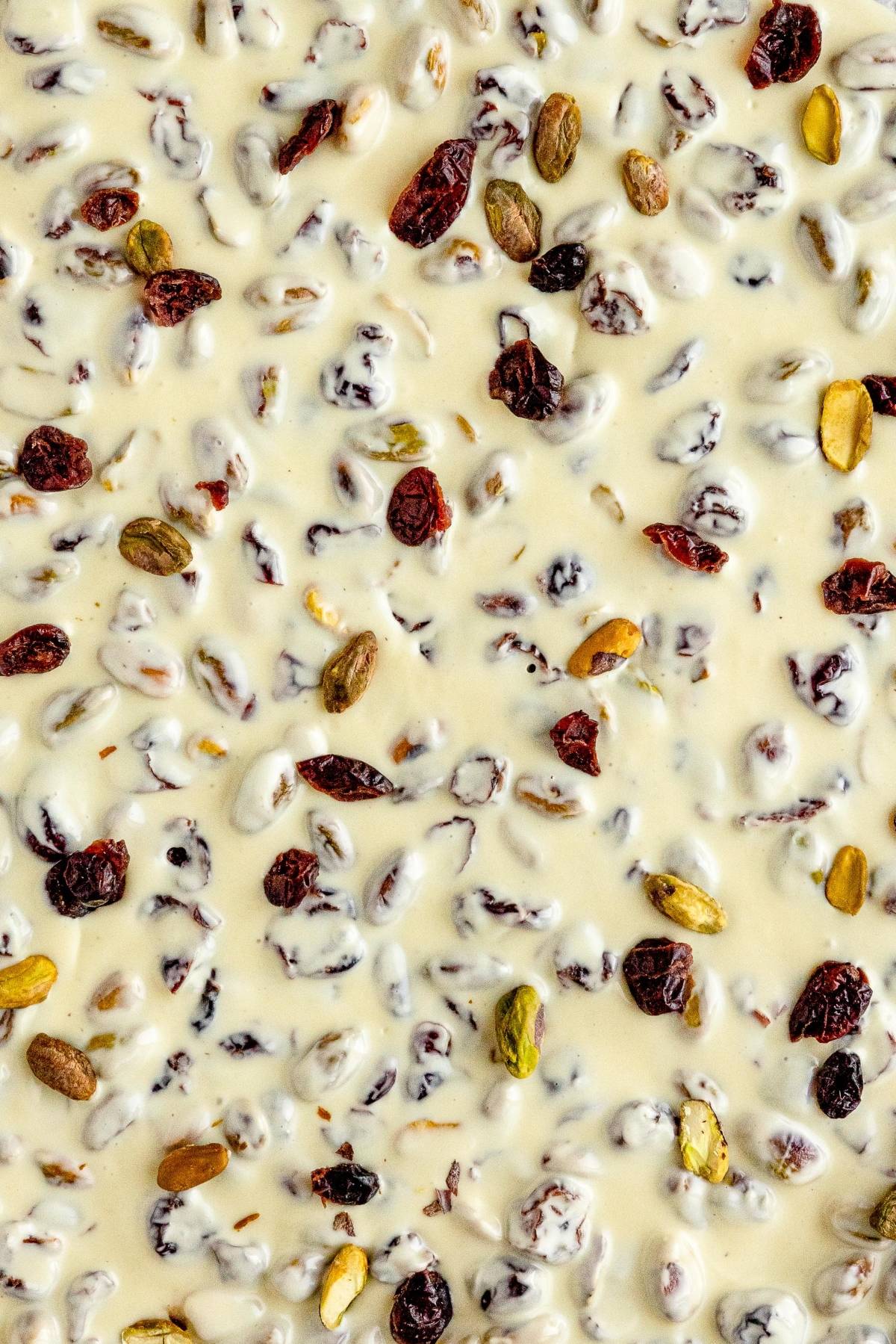 Cranberry Pistachio White Chocolate Bark features creamy white chocolate studded with cranberries, pistachios, and raisins—a festive Christmas bark with pistachios and cranberries in every bite.