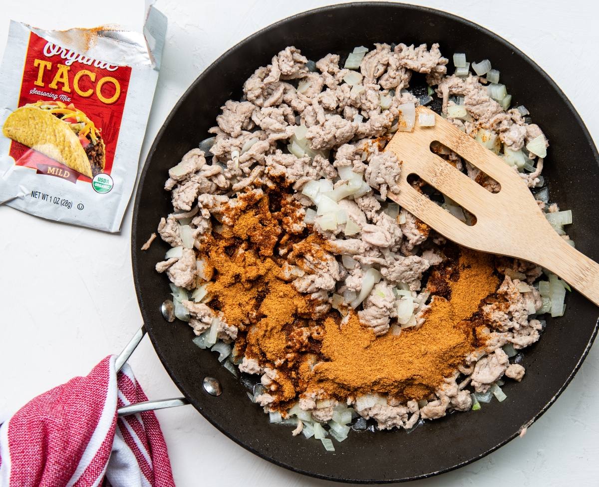 Ground turkey, chopped onions, and taco seasoning sizzle in a skillet—a quick and easy dinner. This recipe with ground turkey is perfect for those learning how to make a crispy taco at home.