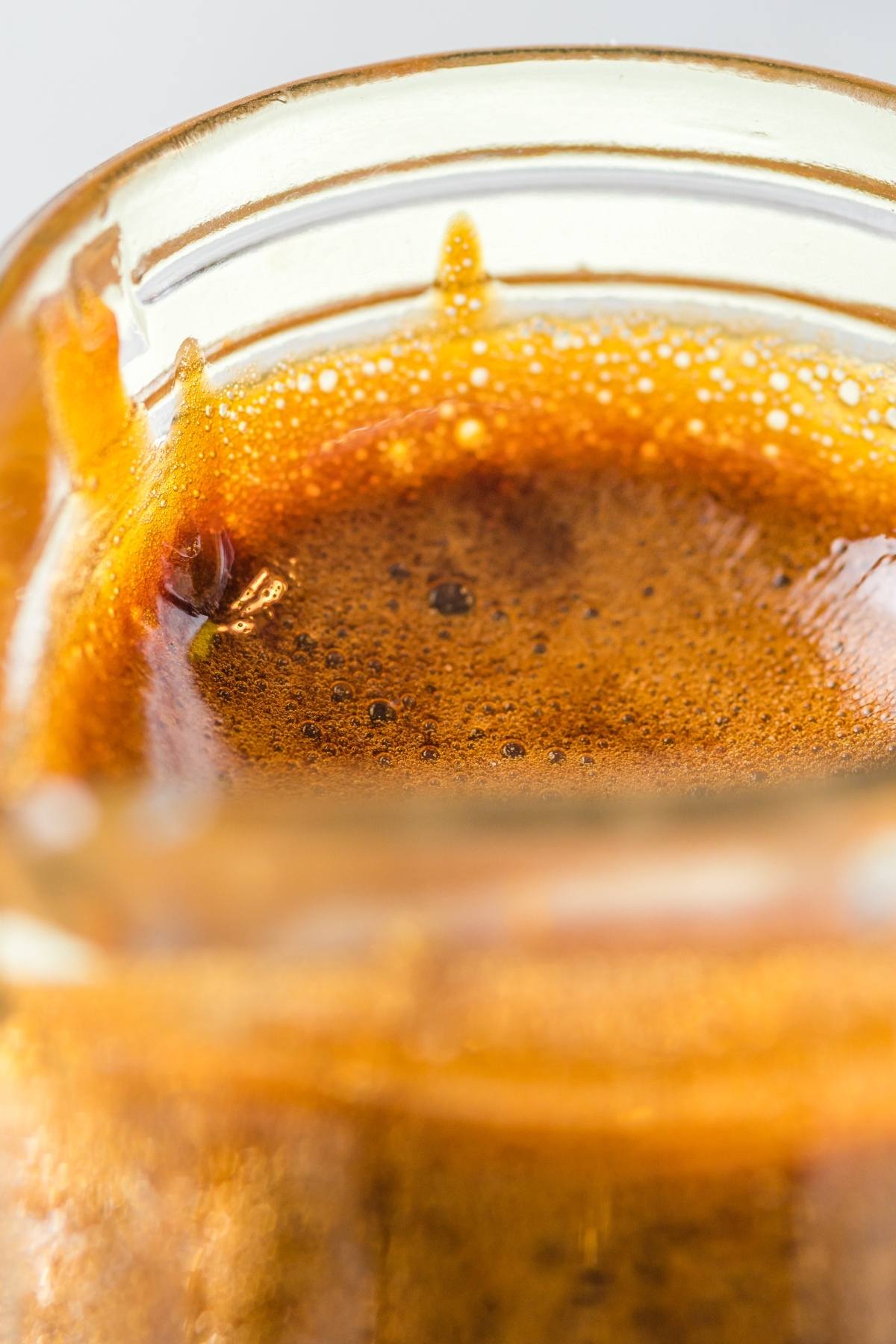Close-up of creamy espresso crema on top of a freshly brewed cup of coffee, as rich and inviting as a homemade unagi glaze.