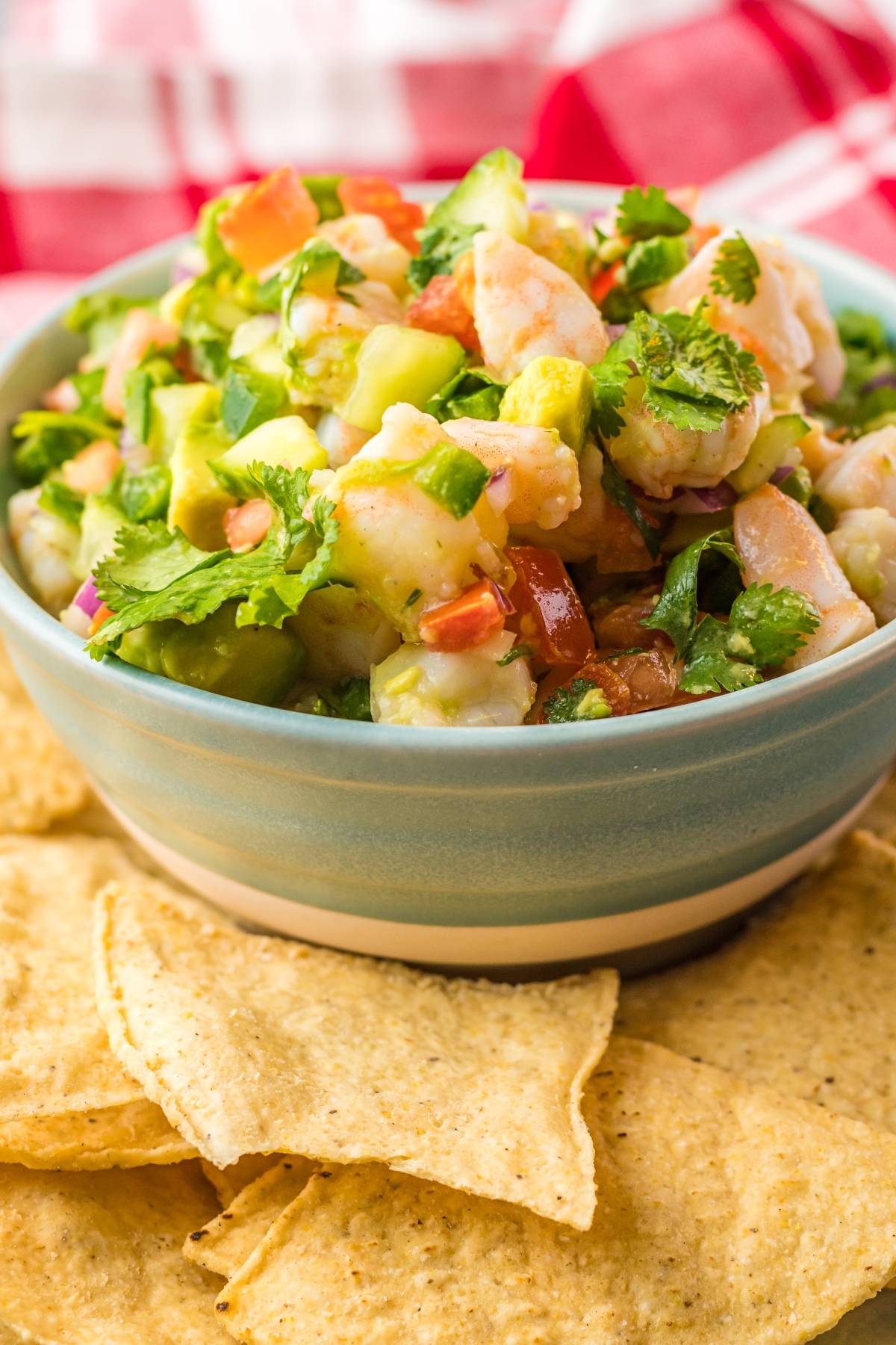 A bowl of Shrimp ceviche with avocado and cilantro, served with tortilla chips on the side—enjoy this refreshing Mexican ceviche perfect for any seafood lover.