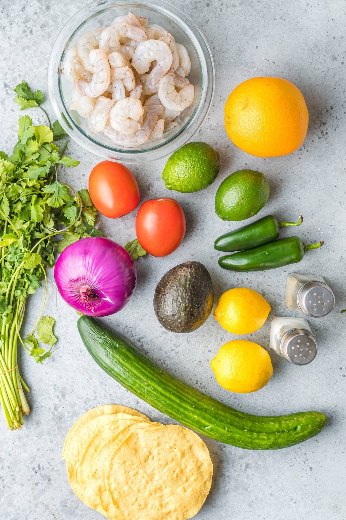 A vibrant Mexican ceviche, this recipe with fresh shrimp features tomatoes, red onion, cucumber, cilantro, avocado, citrus, jalapeños, salt, pepper, and crisp tostadas.