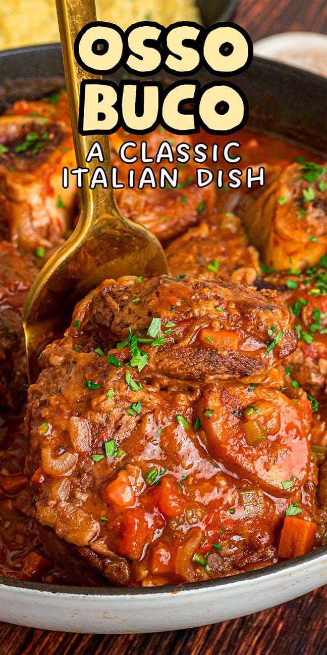 A close-up of osso buco, the classic Italian braised meat dish served with tender vegetables and garnished with chopped herbs.