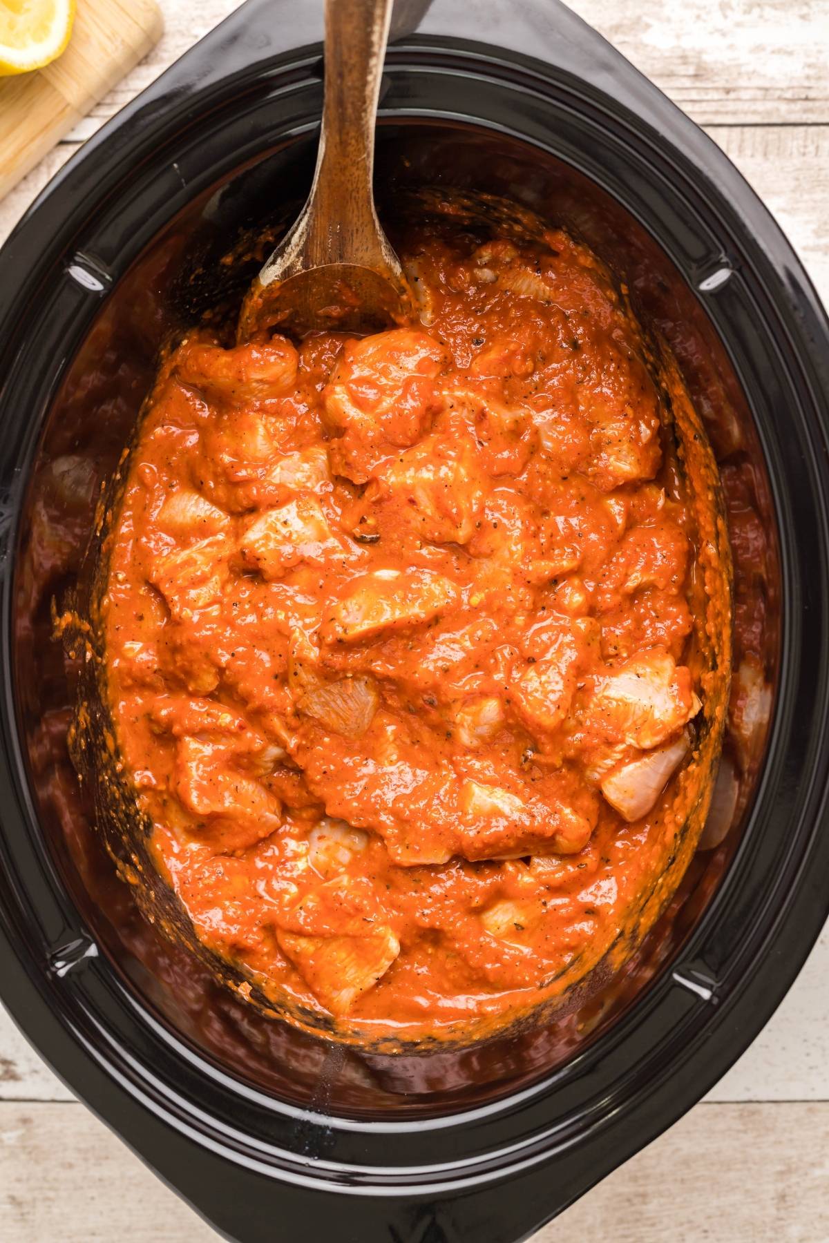 Chunks of chicken in a rich red tomato sauce make this slow cooker butter chicken irresistible, stirred gently with a wooden spoon.