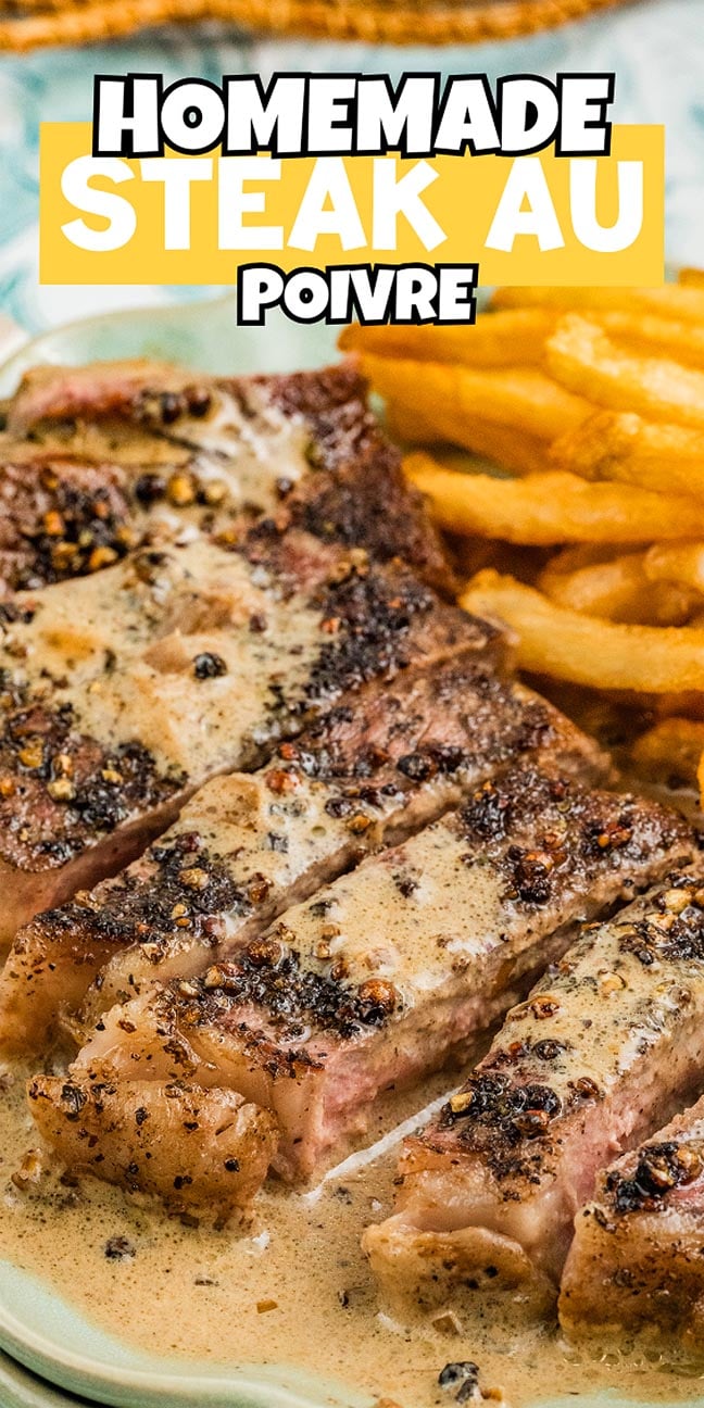Sliced steak au poivre with creamy pepper sauce, served alongside golden French fries on a plate for a classic steakhouse experience.