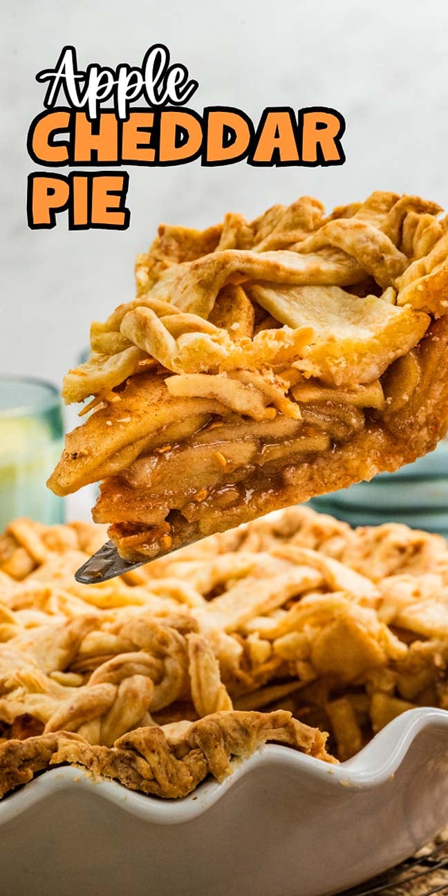 A slice of apple cheddar pie is lifted from a pie dish, revealing its golden lattice crust and the gooey apple cheddar filling inside.