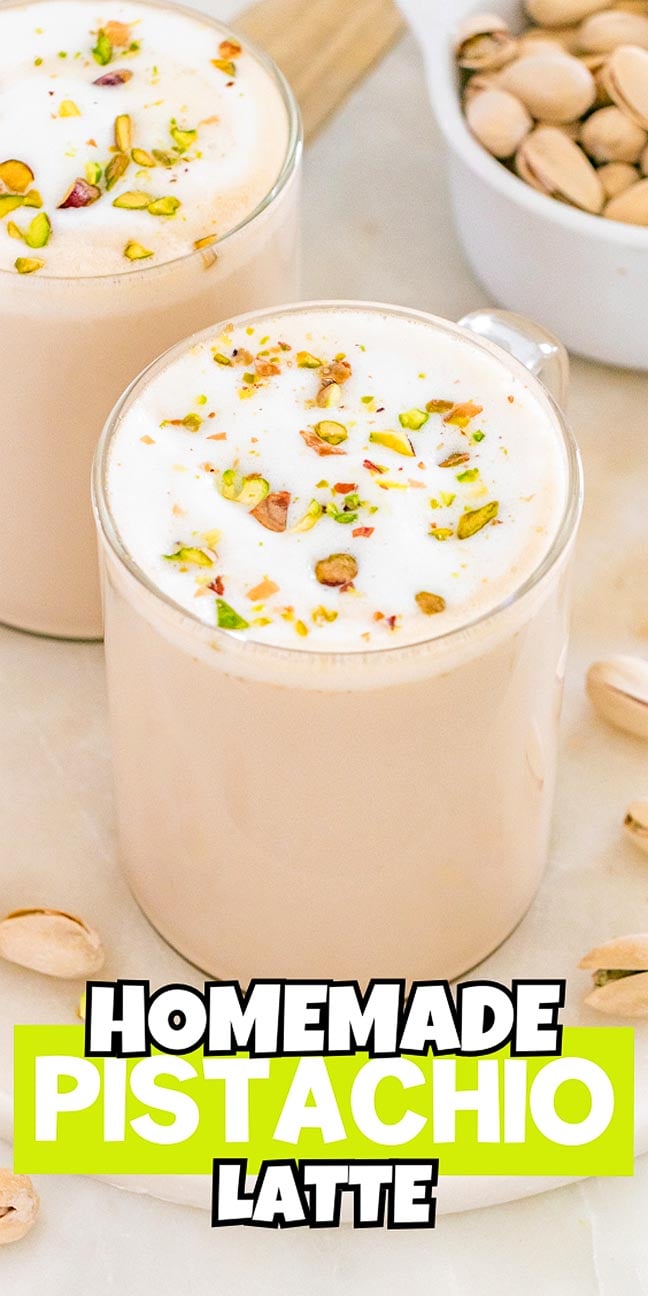 Two mugs of frothy pistachio latte, topped with chopped pistachios, are surrounded by whole pistachios—a perfect treat for any pistachio latte lover.