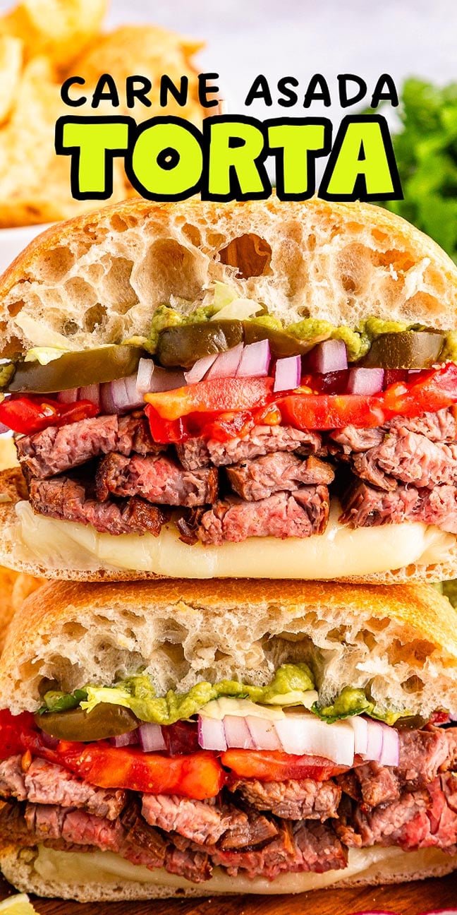 Close-up of a carne asada torta sandwich with juicy steak, onions, tomatoes, cheese, and guacamole all piled high on soft ciabatta bread.