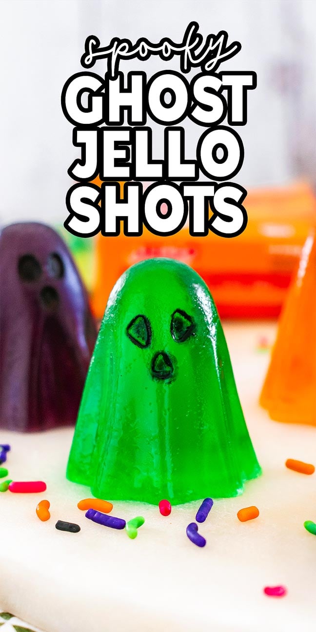 Green ghost-shaped jello shot with candy eyes and mouth, surrounded by colorful sprinkles—a fun twist on classic ghost jello shots for your next party.