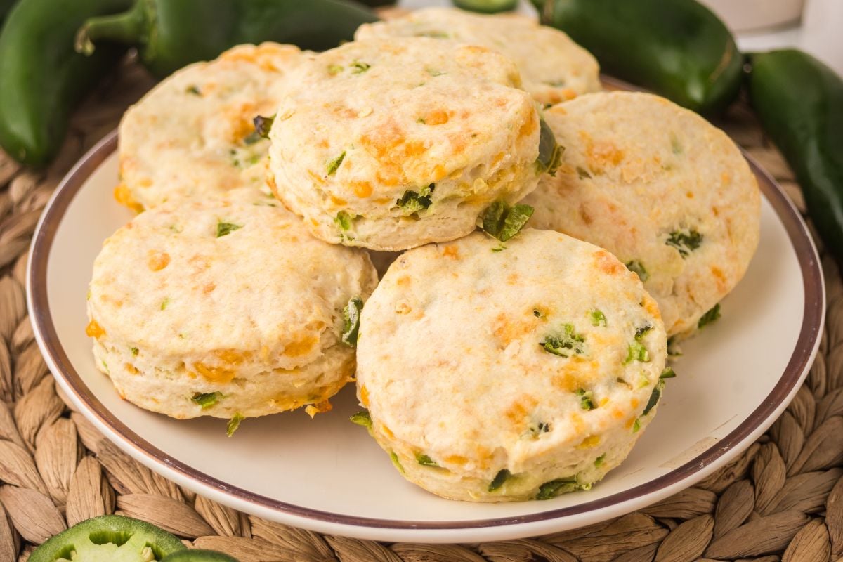 A plate of Jalapeño Cheddar Biscuits with visible cheese and pepper pieces.