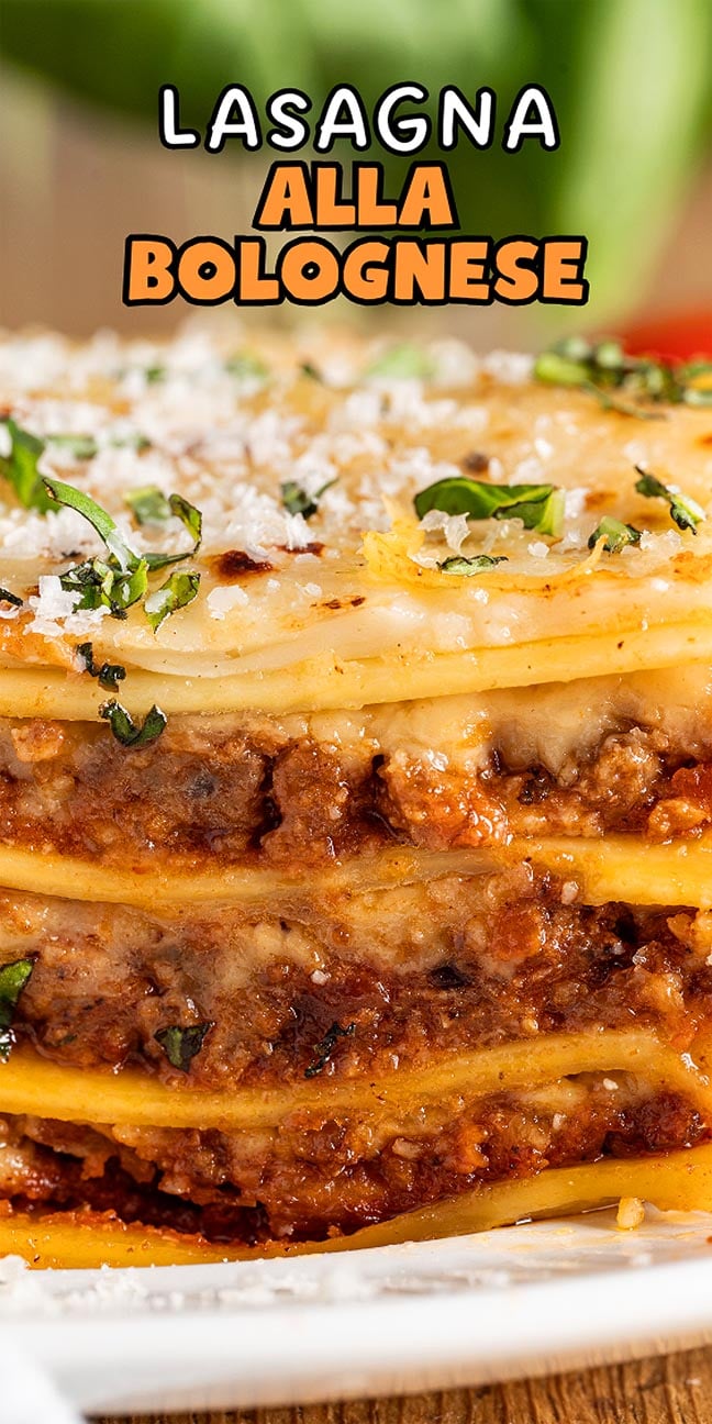 Close-up of lasagna alla Bolognese, showcasing its layers of pasta, savory meat sauce, melted cheese, and fresh herbs.
