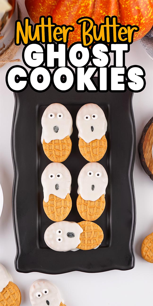 Six Nutter Butter Ghost Cookies decorated with white icing and candy eyes are arranged on a black platter, making a spooky-sweet treat for Halloween.