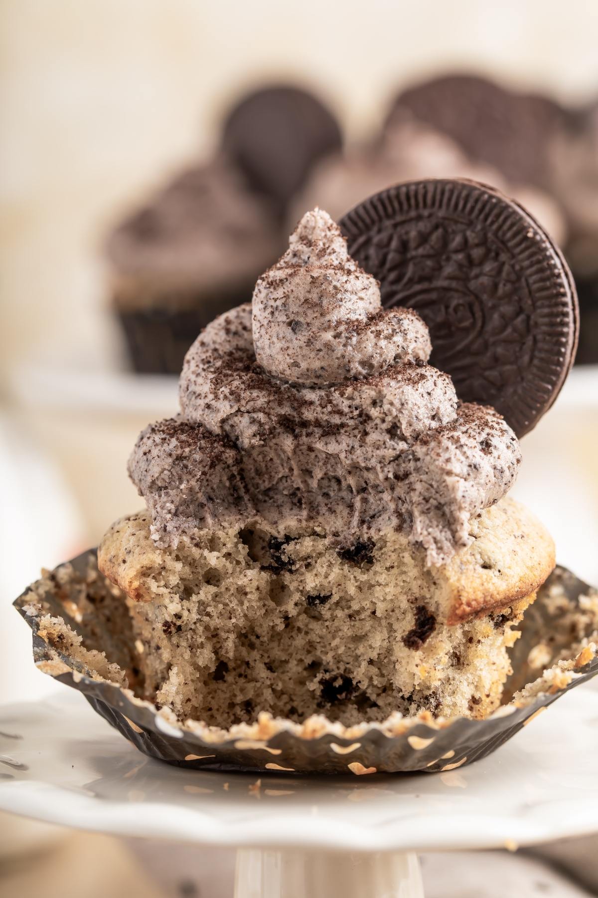 A cupcake with a cookie on top.
