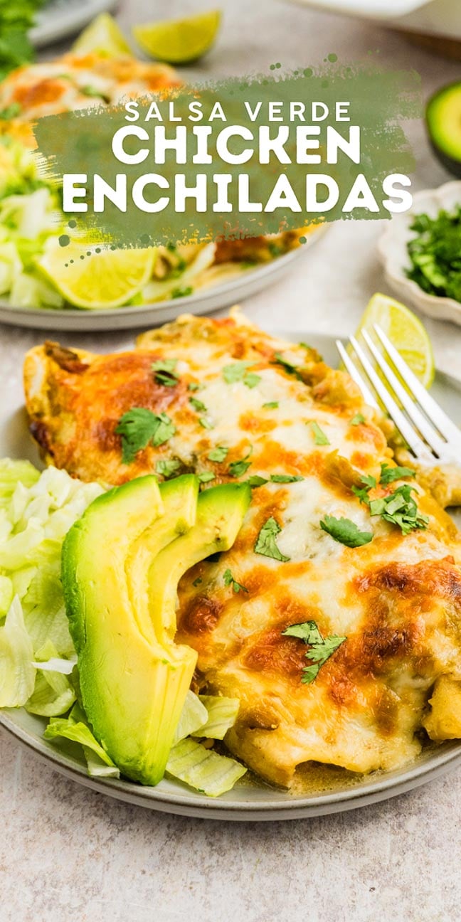 Plate of Salsa Verde Chicken Enchiladas topped with melted cheese, fresh lettuce, avocado slices, and a lime wedge.