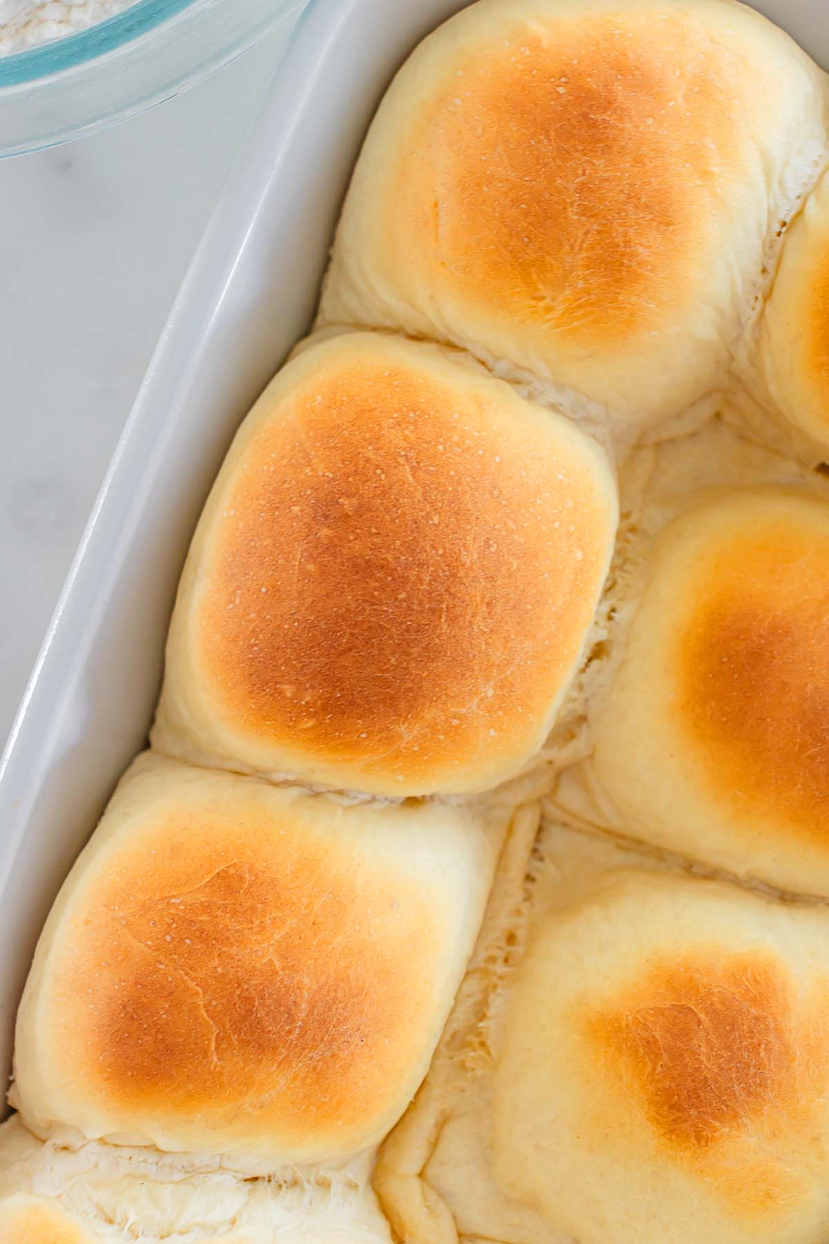 Golden brown 30 Minute Dinner Rolls in a baking dish, fresh from the oven.