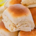 A close-up of a plate piled with golden brown, fluffy 30 Minute Dinner Rolls.