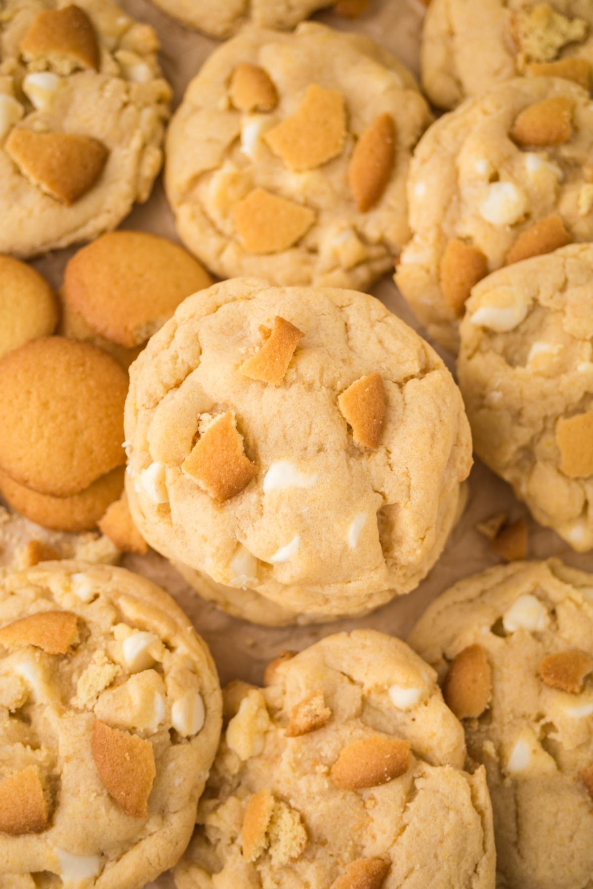 Close-up of cookies with white chocolate chips and pieces of vanilla wafer cookies on top.