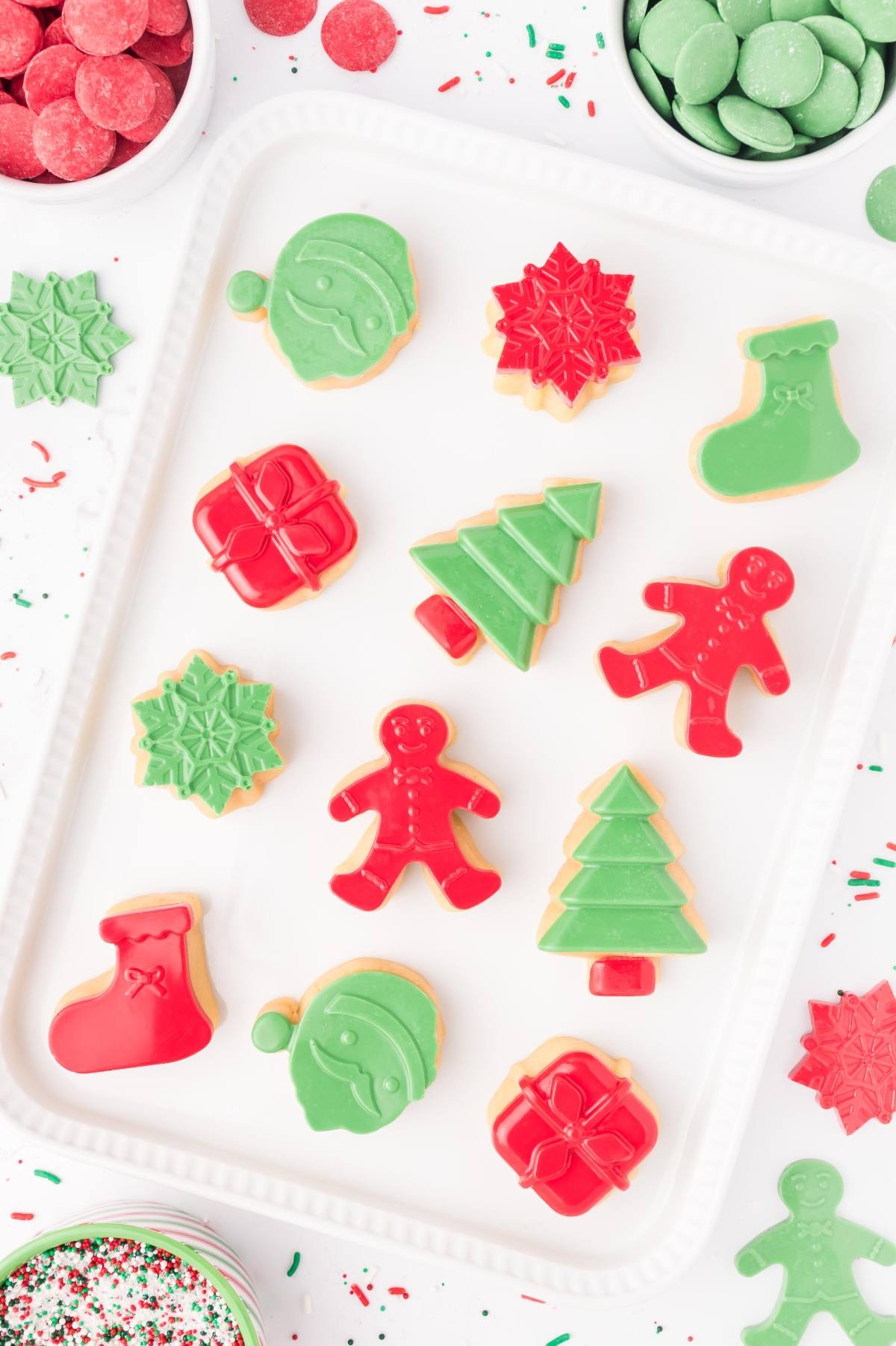 Christmas cookies shaped like trees, stockings, ornaments, and gingerbread people, decorated in red and green.