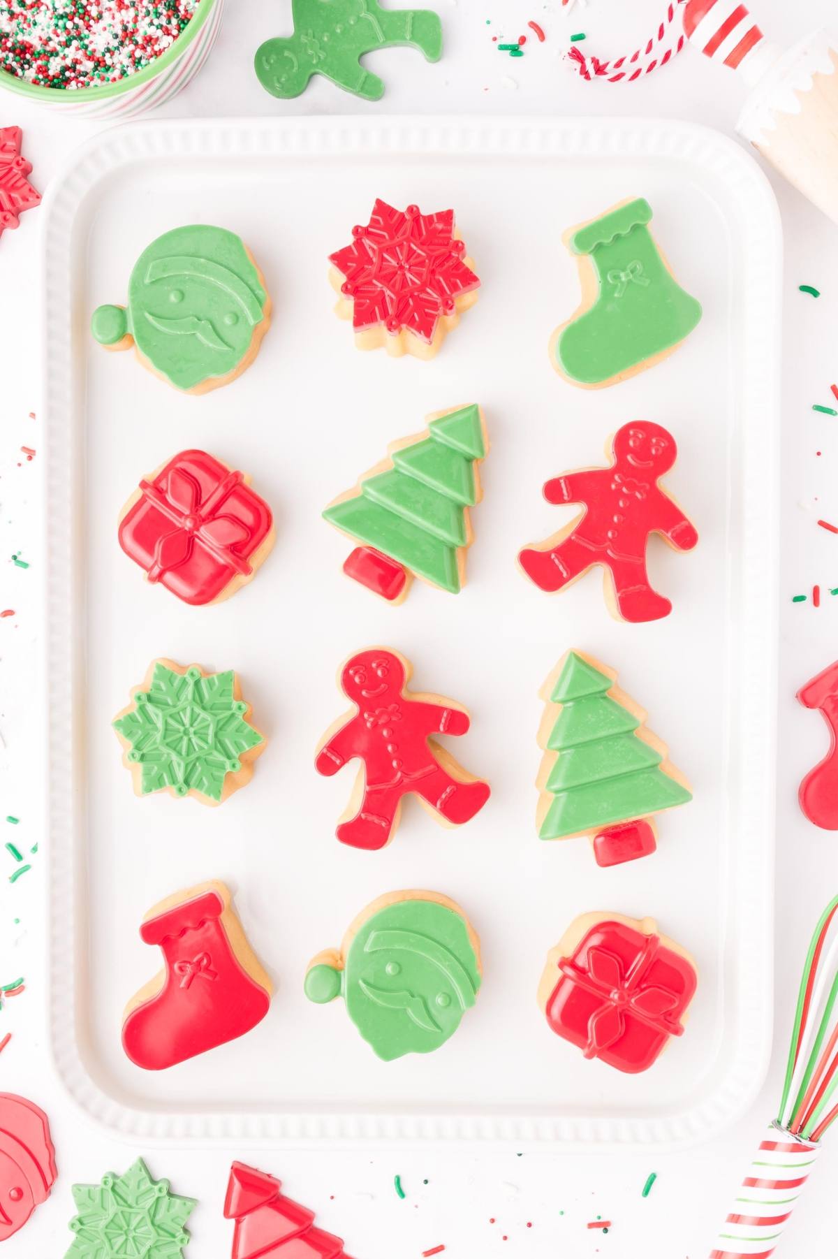 Christmas cookies shaped like trees, stockings, gifts, snowflakes, ornaments, and gingerbread people.