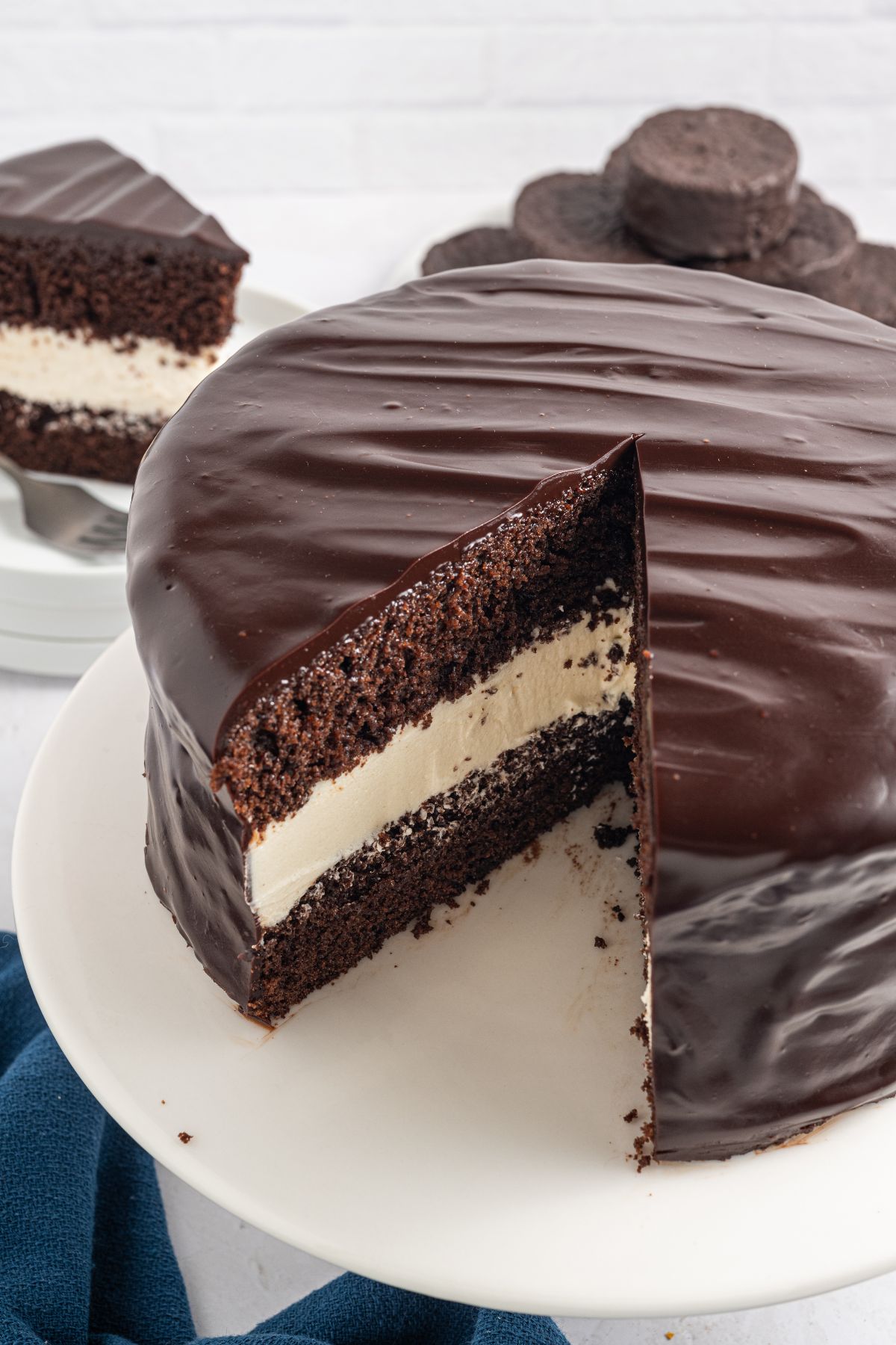 Chocolate cake with a creamy white filling, coated in glossy chocolate, with one slice cut and served—just like a classic Ding Dong Cake.