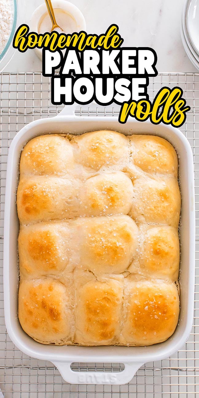 Golden Parker House Rolls in a white baking dish, topped with salt, rest on a cooling rack with a text overlay.