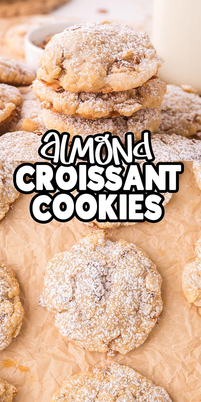 A stack of Almond Croissant Cookies dusted with powdered sugar sits on parchment paper, text overlay reads "Almond Croissant Cookies.