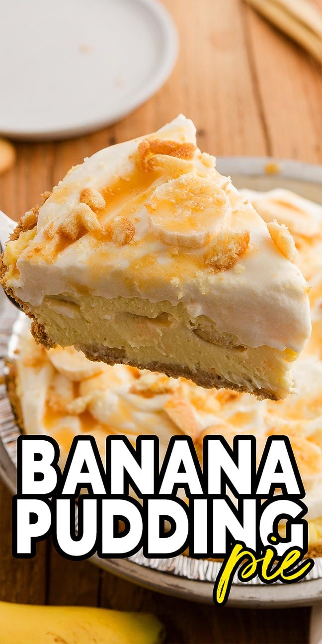 A slice of Banana Pudding Pie with whipped topping and crumbs is held above the whole Banana Pudding Pie, ready to be served.