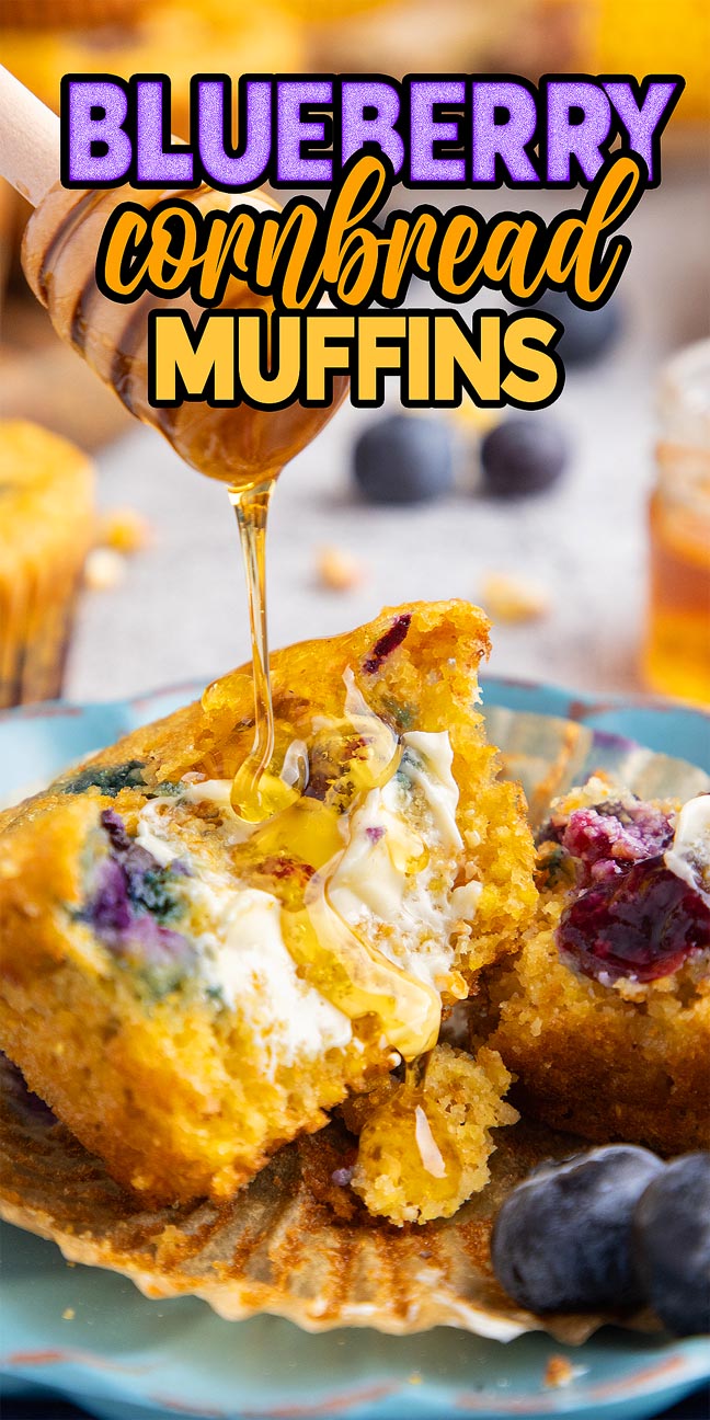 Blueberry Cornbread Muffins split open, topped with butter and honey, served with fresh blueberries on the plate.