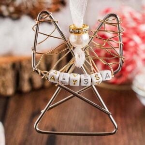 Easy personalized paper clip angel ornament with a pearl head and "Alyssa" spelled on beads, hanging from a white ribbon.