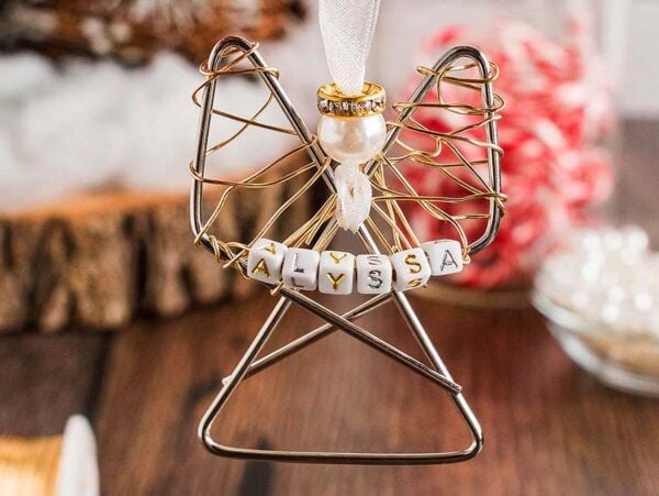 Easy personalized paper clip angel ornament with a pearl head and "Alyssa" spelled on beads, hanging from a white ribbon.