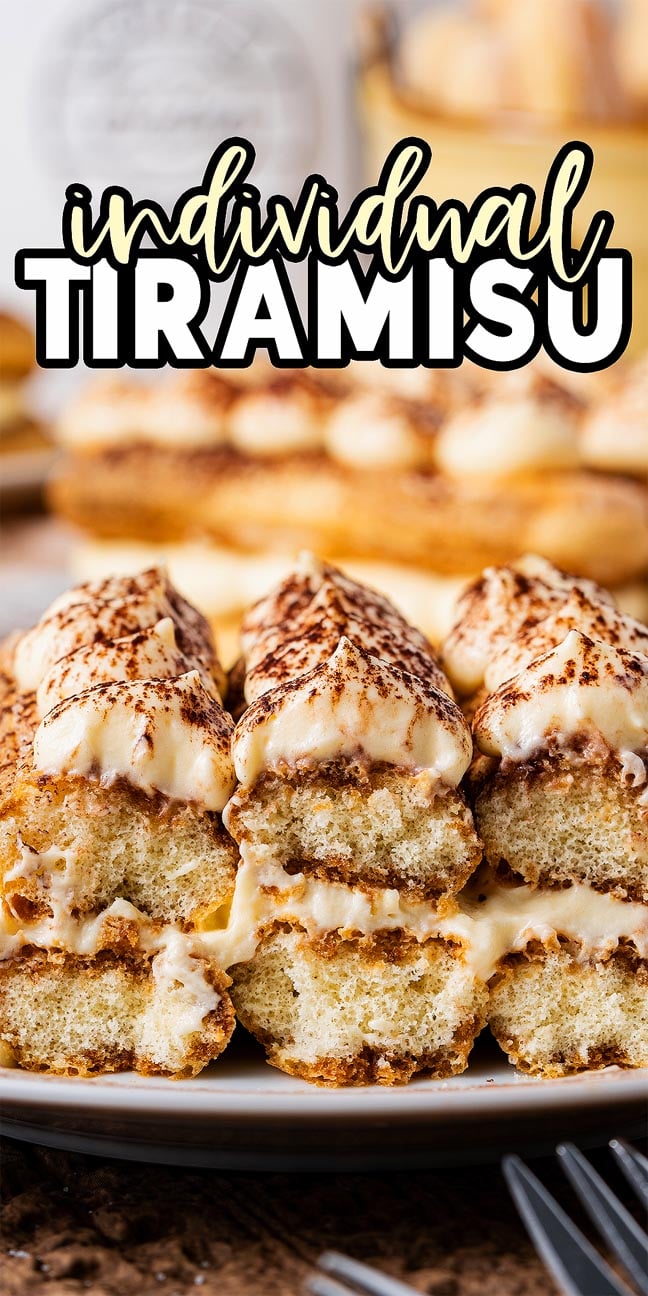 Close-up of individual tiramisu stacked on a plate, each dessert topped with creamy layers and a generous dusting of cocoa powder.