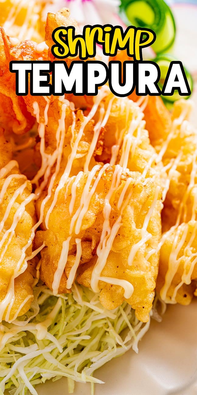 Golden shrimp tempura drizzled with savory sauce, served atop shredded cabbage, with "Shrimp Tempura" displayed above.