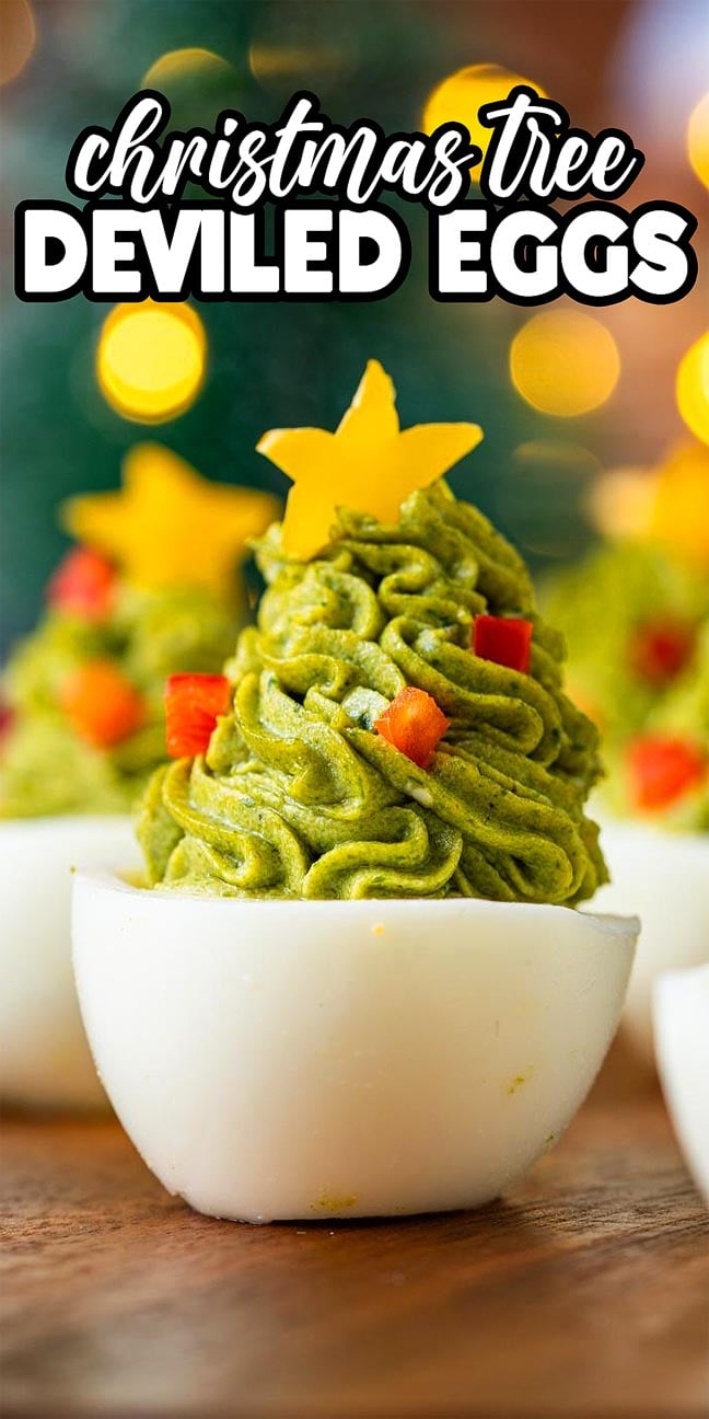 Christmas Tree Deviled Eggs topped with green filling shaped like festive trees, adorned with stars and red pieces for a delightful holiday treat.